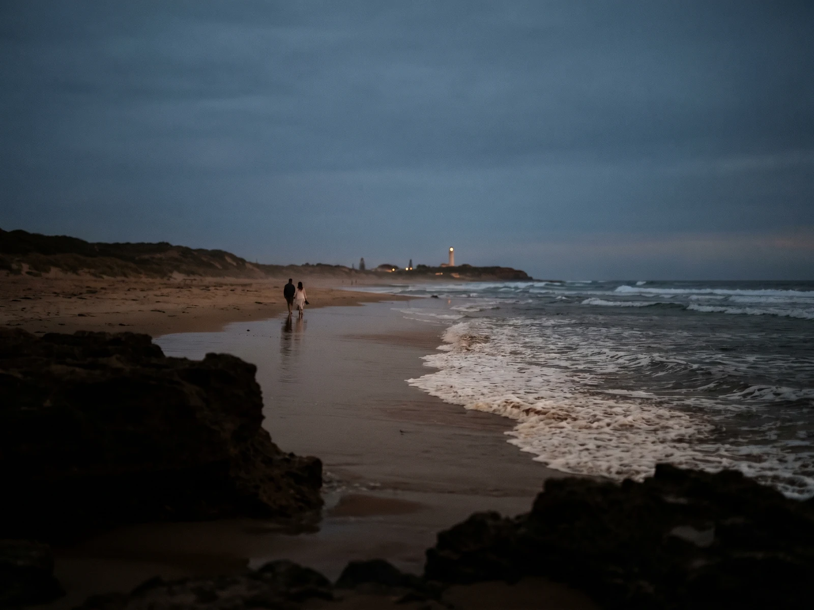 Couple alone at blue hour on the coast